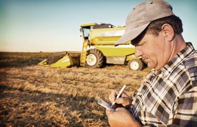 Farmer with Pen and Notepad in Field