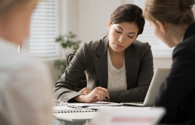 Businesswoman Taking Notes with Woman Client