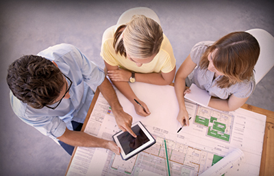 Group Reviewing Plans with Tablet
