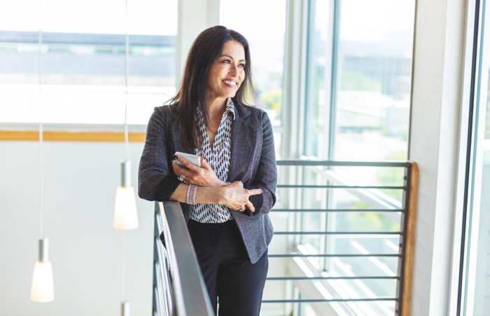 Business women smiling on balcony