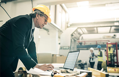 Construction - Guy At Computer <img src=”construction.jpg” alt=”Guy in hard hat at computer”>