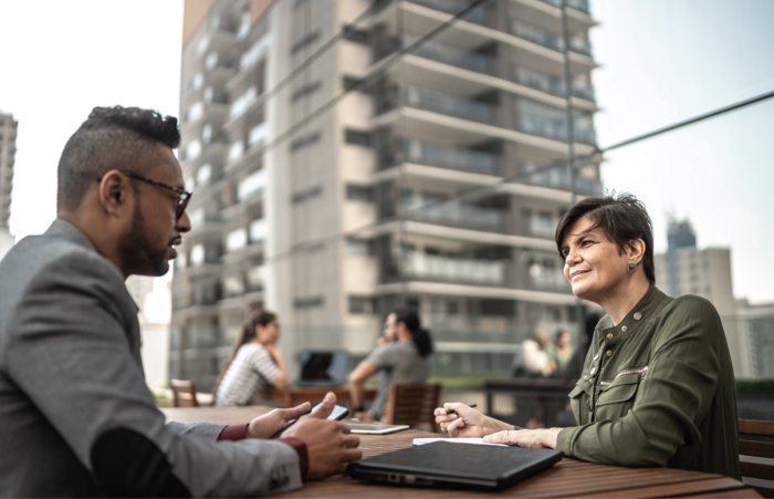 Colleagues having a meeting outdoors
