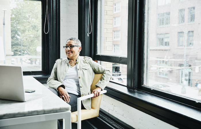 woman at desk with windows