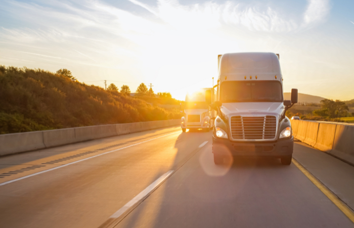 18 wheeler truck on road at sunrise