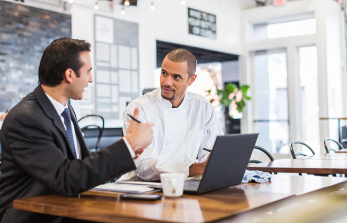 Business mans peaking to chef