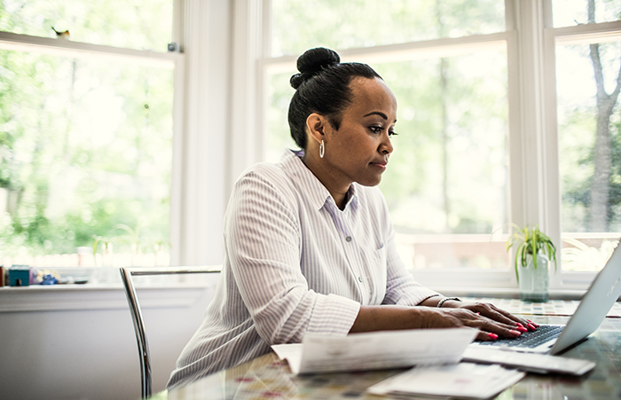 Womanworkingonlaptopatdesk