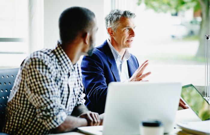Business man leading discussion at meeting