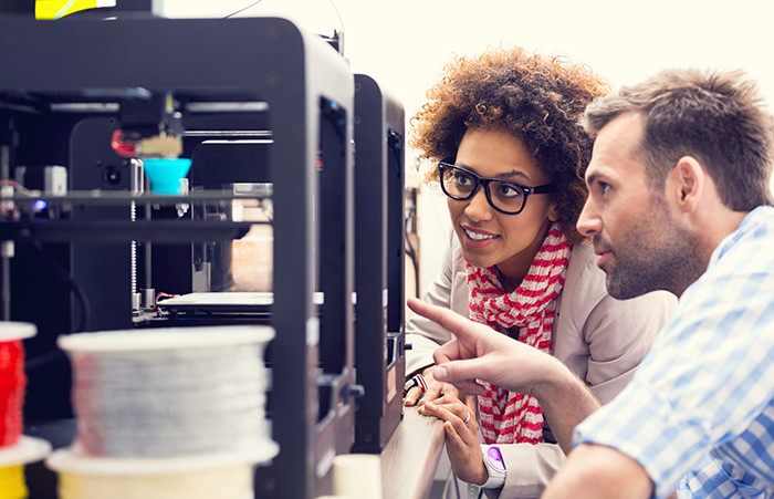 coworkers analyzing machine