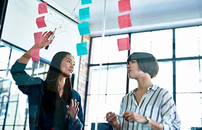 colleagues looking at sticky notes
