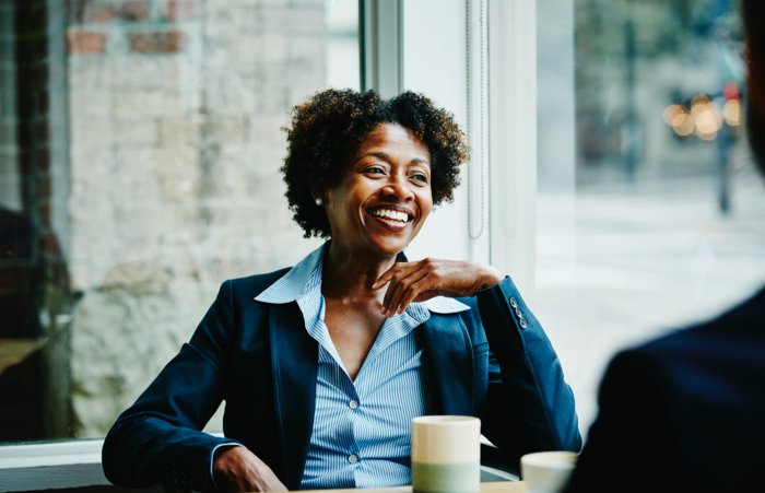 Business woman in meeting with colleagues in cafe