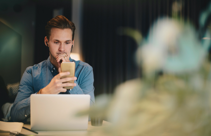 Man on phone and laptop