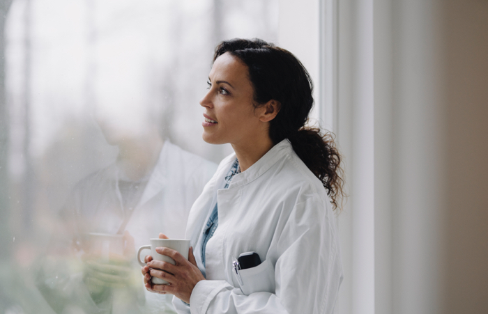 Medical professional looking out window