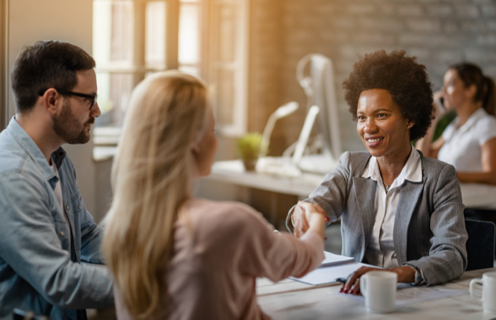 Agent shaking hands with clients