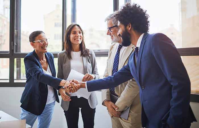 Handshake Between Colleagues in Group Meeting