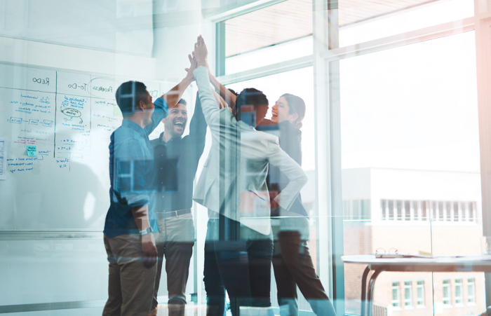 Team celebrating in conference room