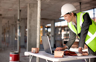 Woman On Construction Jobsite Laptop
