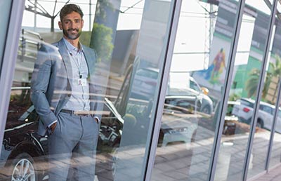 Salesman Looking Out Showroom Window