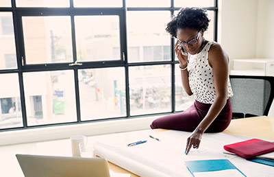 Business Woman Sitting On Desk