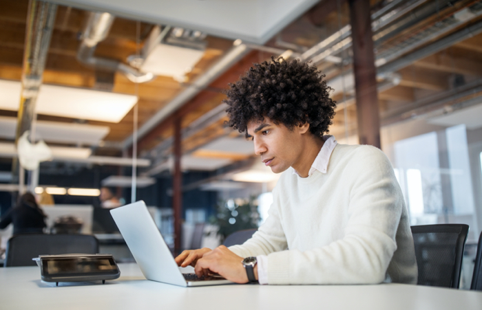 Businessman Using Laptop on Desk