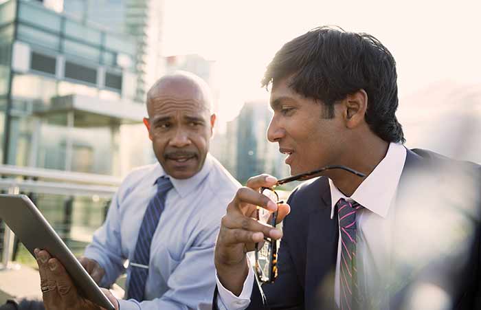 Businessmen Outside Viewing Tablet