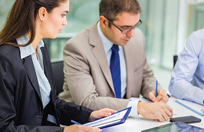 BusinessPeopleFillingOutPaperwork