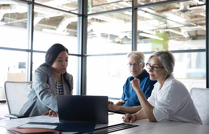 Businesswoman Going Over Financial Plans with Couple
