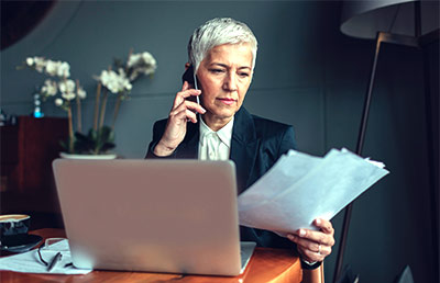 Businesswoman Reviewing Papers Phone