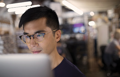 Close Up Focused Individual Working on Computer