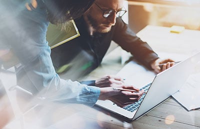 Collaborating Over Shoulder Guy With Glasses