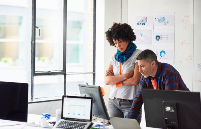 Colleagues-working-on-computer-in-start-up-office