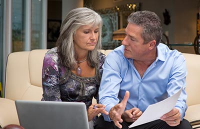 Couple Concerned Reviewing Document