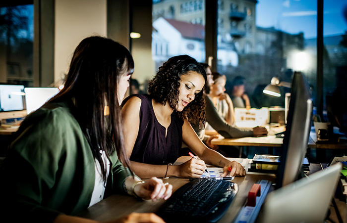 Creative business people working late on a computer
