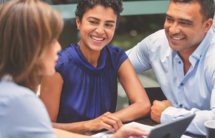 Happy Couple Meeting with Advisor