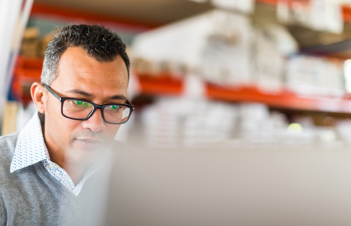 Man With Laptop in Warehouse