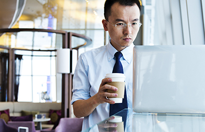 ManWithCoffeeLaptopGlasses