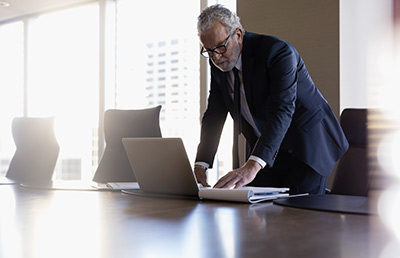 Older Businessman Reviewing Laptop