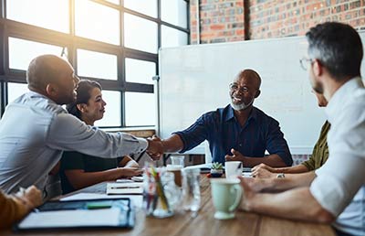 Older Man Leading Meeting Handshake