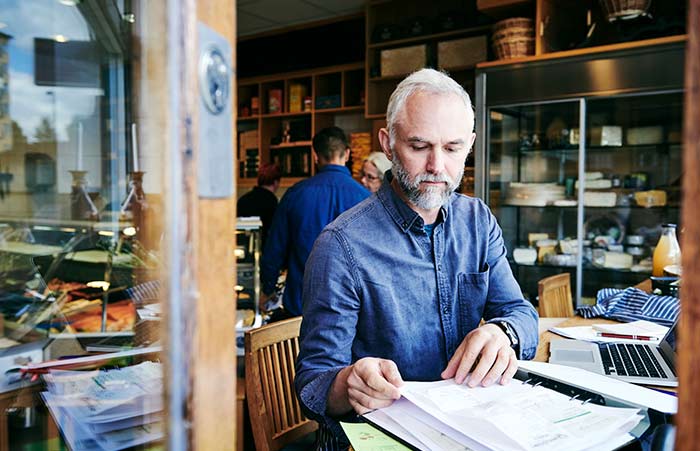 Shop Owner Reviewing the Books