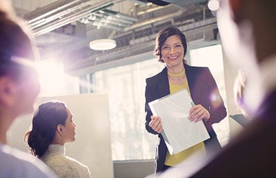 Smiling Businesswoman Leading Office Meeting