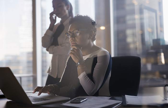 Thoughtfully Looking at Laptop