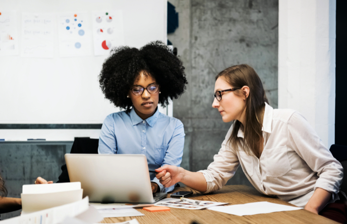 Two Women Having Discussion in Office