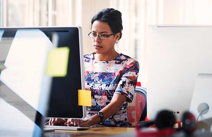 Woman Looking at Computer Serious