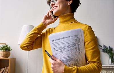 Woman on Phone Tax Forms