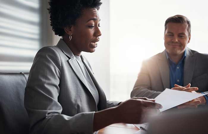 Woman Table Reading From Sheet