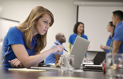 Woman Working on Computer in Conference Room