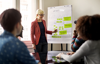 Woman Pleasantly Presenting Conference Room