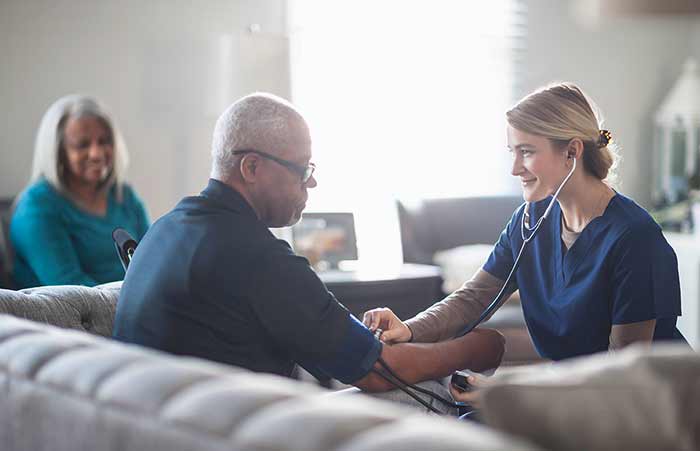 Nurse Checking Patients Blood Pressure in Home