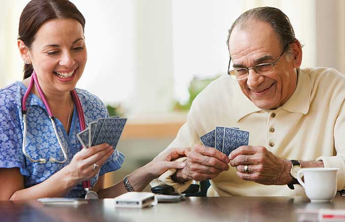Nurse Playing Cards with Elderly Man