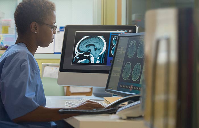 Woman Radiologist Viewing Xray on Screen