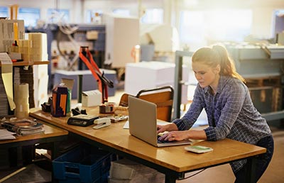 Manufacturing Facility Woman at Work Laptop